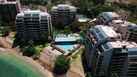 Static-drone-shot-of-Maui-resort-buildings-with-triangular-pool-and-beach