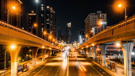 Bird's-night-light-view-of-multi-level-junction-road-lands-with-moving-cars-traffic-of-modern-highway-with-overpass-bridge-at-countryside