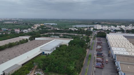 Footage-of-the-highway-intersecting-with-a-smaller-road-leading-to-a-village,-highlighting-the-connectivity-between-urban-and-rural-areas