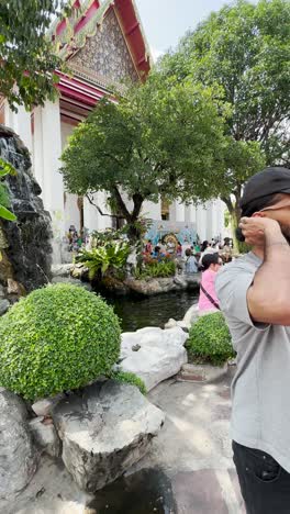 People-are-sitting-in-the-garden-of-the-temple-in-the-peaceful-atmosphere-of-the-temple