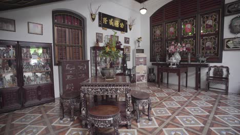 Approaching-Shot-Between-Pillar-and-Indoor-Tree-Towards-Historic-Asian-Furniture