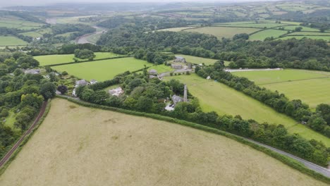 Drone-fly-over-of-the-lush-Cornish-landscape-with-prominent-old-mining-ruins-from-the-industrial-revolution