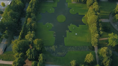 Top-down-view-on-the-amazing-green-castle-park,-view-on-the-Schloss-and-city-of-Schwerin-in-germany-in-slow-motion,-strong-colors