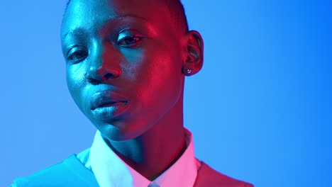 Close-up-portrait-of-a-strong-confident-Black-woman-with-her-chin-up,-looking-down-at-the-camera