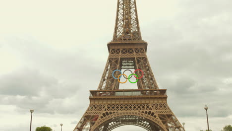 Upwards-tilting-shot-of-the-Eiffel-tower-with-the-Olympic-Rings-logo