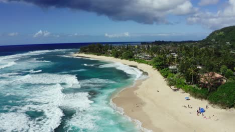 Drone-shot-of-Oahu's-North-Shore-beach-at-midday