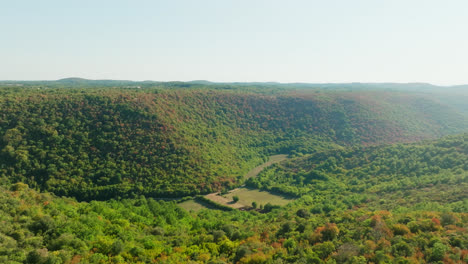 AERIAL:-Extreme-wildfire-risk-in-a-highland-valley-with-a-river-and-green-vegetation