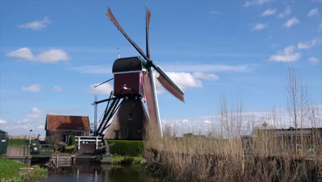 In-the-quiet-symphony-of-the-breeze,-traditional-Dutch-windmill-rotates