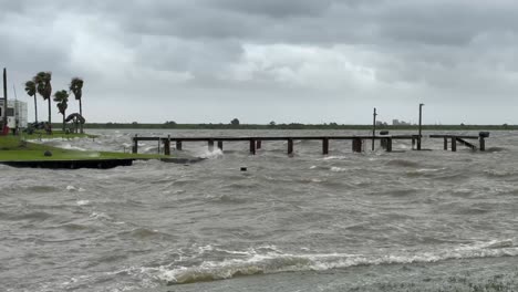 In-the-aftermath-of-Hurricane-Baryl,-Galveston-Bay-on-the-Texas-Gulf-Coast-lies-in-ruins-as-storm-surge-and-heavy-winds-leave-a-broken-boat-dock-battered-and-submerged