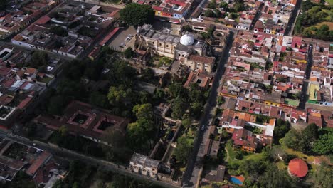 Fly-over-Antigua’s-cobblestone-streets,-colonial-architecture,-and-lush-landscapes