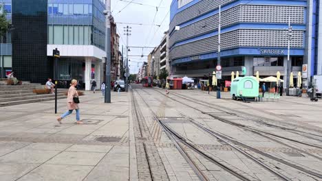 Tram-tracks-and-modern-buildings-in-Katowice's-bustling-Market-Square,-Poland