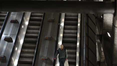 Going-down-on-the-escalator,-Westminster-Station,-London,-United-Kingdom