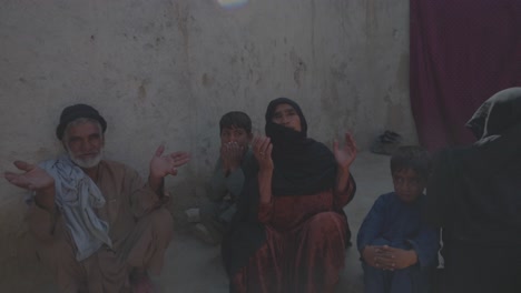 Needy-Adult-Afghan-Woman-Making-Dua-and-Praying,-Footage-shows-an-Afghan-adult-woman,-visibly-poor-and-in-need,-performing-a-dua-with-her-hands-raised