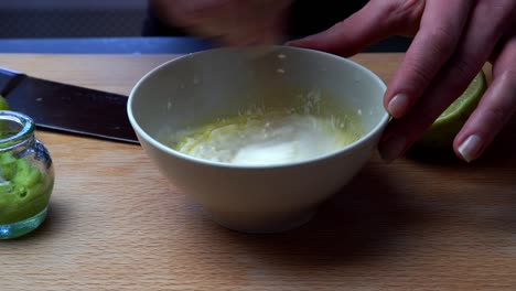 Chef-Mixing-Mayonnaise-And-Olive-Oil-In-Bowl