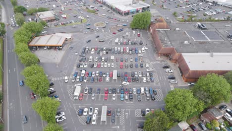 Drone-orbital-view-of-Sainsbury's-in-Bridgwater,-featuring-the-main-building,-parking-lot,-and-adjacent-streets,-Bridgwater,-United-Kingdom,-July-2024