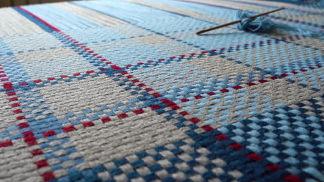 Close-up-of-Handwoven-Blue-and-Red-Checkered-Fabric-with-Needlework