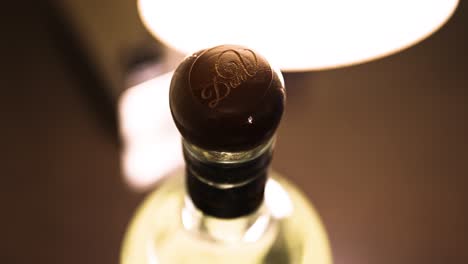 close-up-of-a-wooden-engraved-cork-of-a-bottle-of-Don-Vicente-Reposado-tequila-being-lit-by-a-warm-lamp-lighting