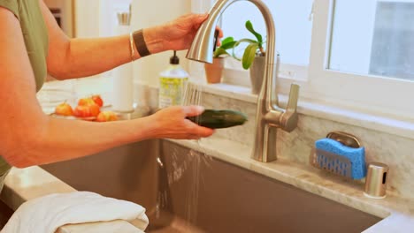 A-woman-washing-a-fruits-and-vegetables-in-a-sink