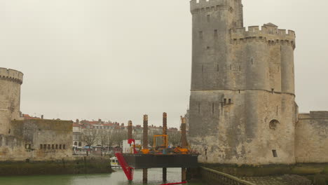 Shot-of-exterior-architecture-of-Towers-of-La-Rochelle-in-France-on-a-misty-day