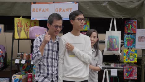 Family-wherein-mother-and-father-pose-with-their-son-having-autism