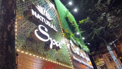 Natural-Spa-Massage-large-vertical-sign-in-lights-in-Hanoi,-Vietnam