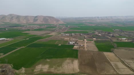 An-aerial-shot,-captured-by-drone-of-a-rural,-agricultural-landscape-in-a-remote-village-setting-located-within-Afghanistan