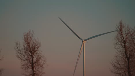 Wind-turbine-spinning-at-sunset-in-slow-motion