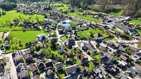 Hallstatt-drone-shot-with-houses-and-river-in-Austria