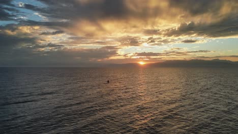 Sea-kayaking-into-sunset,-Aerial-view