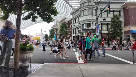 Families-and-Visitors-in-busy-street-walkway-scene-with-shops-and-attractions-at-Universal-Studios-Japan