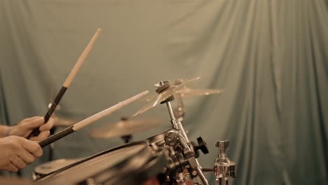 Slow-motion-footage-of-a-drummer's-hands-wielding-two-drumsticks,-alternating-left-and-right-strikes-on-a-cymbal