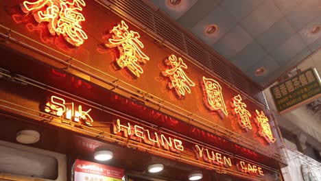 Golden-Neon-Sign-Glowing-At-Exterior-Facade-Of-Chinese-Coffee-Shop-In-Hong-Kong