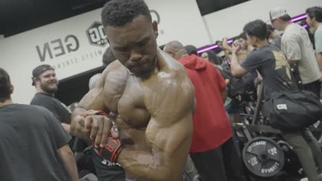 An-African-American-man-admires-his-toned-physique-in-the-reflection-of-the-mirror