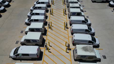 slowly-backing-drone-shot-of-USPS-trucks-near-rows-of-newly-installed-chargers