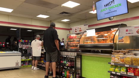 Pan-shot-of-people-line-up-for-paying-food-at-7-eleven-check-out-counter