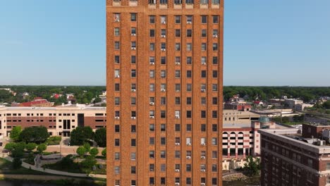 Vista-Aérea-De-Cerca-Del-Alto-Edificio-De-Apartamentos-De-Ladrillo-En-La-Ciudad-Americana