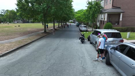 Aerial-flyover-jogging-people-on-street-of-american-town