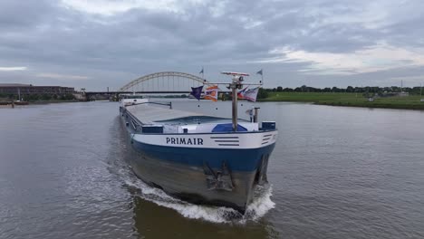 Ship-PRIMAIR-Sailing-In-Alblasserdam,-Netherlands-On-A-Cloudy-Day---Drone-Shot