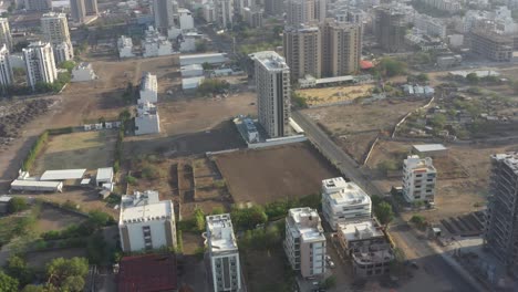 Drone-camera-shows-a-lot-of-vehicles-moving-on-the-road-and-a-lot-of-building-construction-going-on