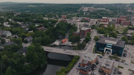 Aerial-View-Of-Landmark-Buildings-And-Rue-Belvedere-Nord-Bridge-Above-The-Magog-River-In-Sherbrooke,-Quebec,-Canada