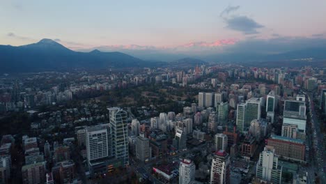 Fly-over-establishing-Santiago-Chile,-El-Golf-neighborhood-with-residential-and-office-buildings-with-the-Andes-mountain-range-in-the-background