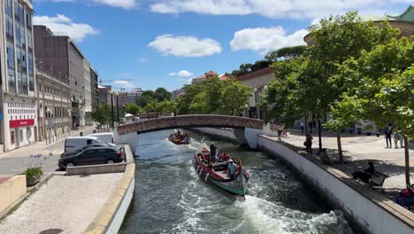 Point-of-view-of-the-tourists-happily-aboard-the-traditional-Moliceiro-Tour-Boats,-navigating-on-Aveiro-Canal-in-Portugal