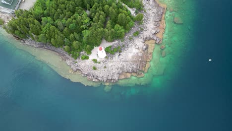 Aerial-ascent-topdown-view-of-Big-Tub-Lighthouse,-Tobermory,-Canada