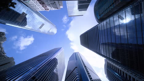 Modern-business-architecture-with-glass-and-steel-walls-reflecting-sky-clouds