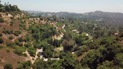 Aerial-flight-over-mountains-with-street-and-villas-in-Beverly-Hills-during-sunny-day