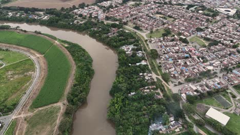 High-altitude-view-looking-east-across-Cali,-Colombia,-with-a-focus-on-Cauca-River-in-South-America