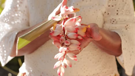 Woman-Holding-Alpinia-Zerumbet-On-Her-Hands---Close-Up