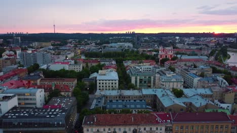 Slow-Tracking-Aerial-Shot-of-Vilnius,-Lithuania-at-Golden-Hour