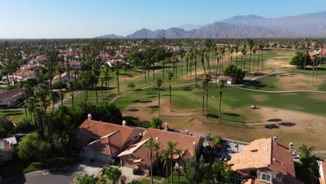 Drone-soars-above-desert-trees-and-golf-course-in-Palm-Springs-California-USA