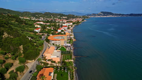 Drone-shot-of-beachside-city-at-Greece-with-beautiful-seascape-at-background